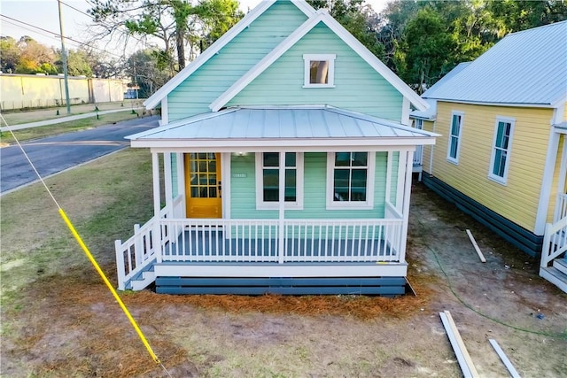 back of house featuring covered porch