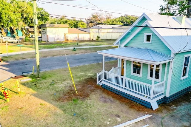 exterior space with covered porch and a lawn