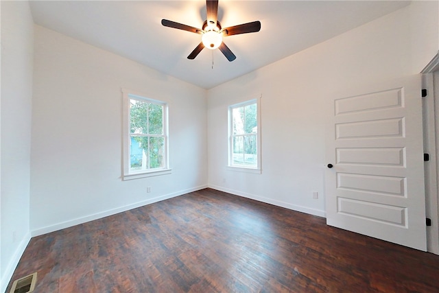 empty room featuring ceiling fan and dark hardwood / wood-style flooring