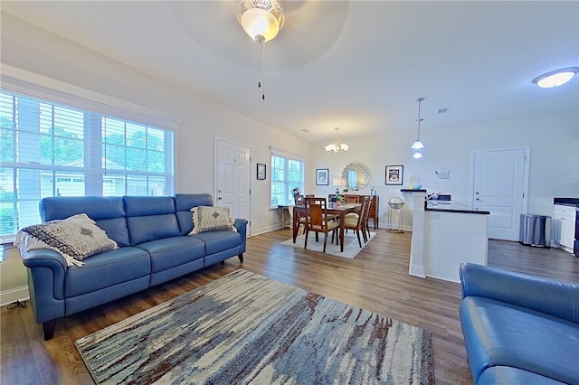 288 Bridgewater Ln, Darien, GA 31305 - living room with ceiling fan, wood finished floors, and a chandelier
