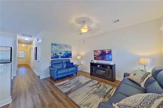 288 Bridgewater Ln, Darien, GA 31305 - living room with wood finished floors, a ceiling fan, and attic access