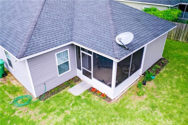 288 Bridgewater Ln, Darien, GA 31305 - rear view of house with a shingled roof and a sunroom