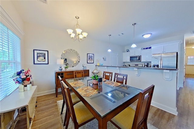 288 Bridgewater Ln, Darien, GA 31305 - dining room featuring light wood-style flooring and a chandelier