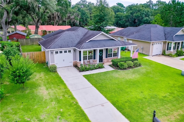 288 Bridgewater Ln, Darien, GA 31305 - view of front of home with an attached garage, driveway, roof with shingles, a porch, and stone siding