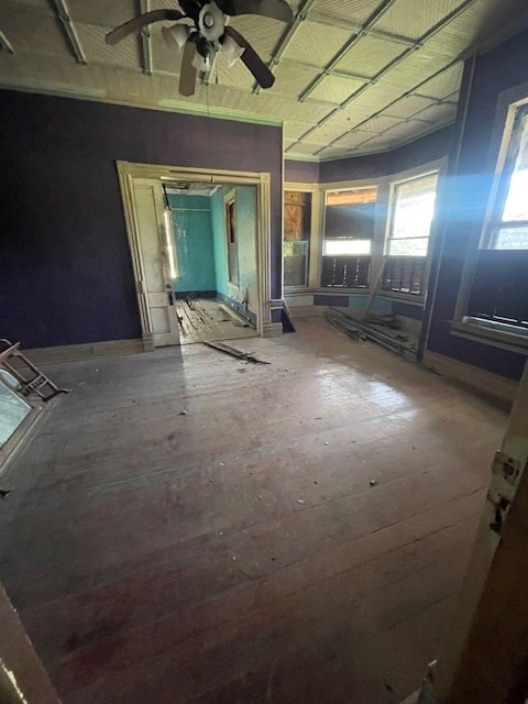 spare room with baseboards and a ceiling fan