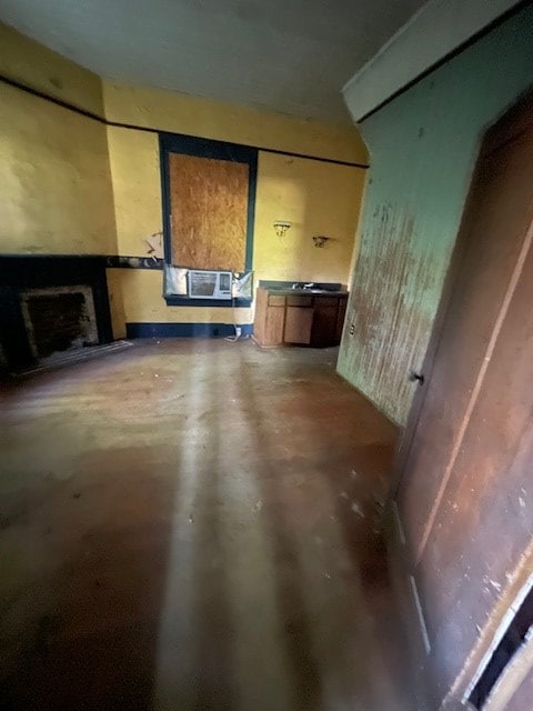 unfurnished living room with cooling unit and concrete flooring
