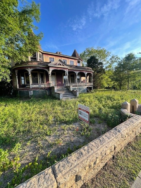 back of house featuring a porch