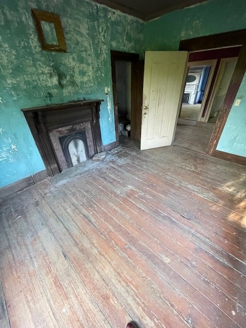 unfurnished living room featuring a fireplace and hardwood / wood-style flooring