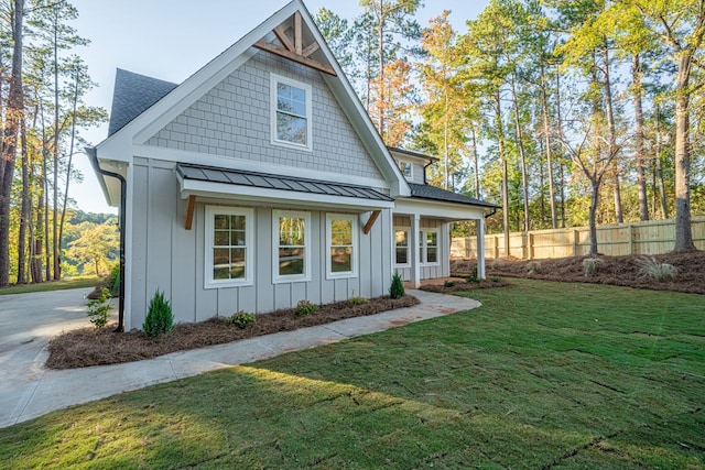 rear view of property with a lawn