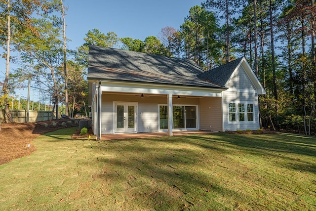 back of house with a yard, ceiling fan, and french doors