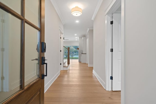 hallway featuring light hardwood / wood-style flooring and ornamental molding