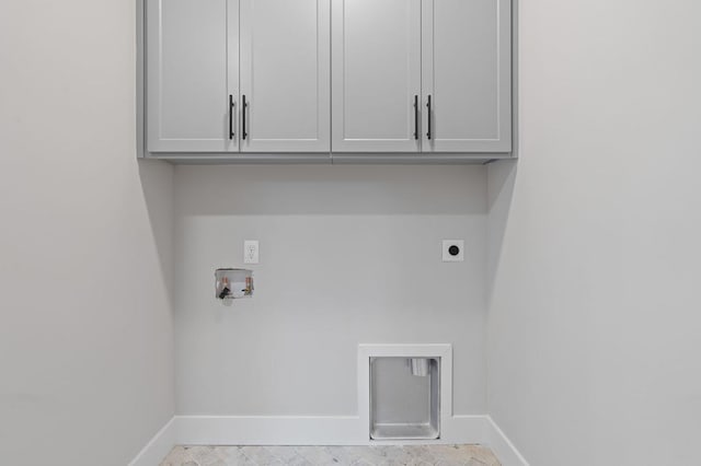 clothes washing area with hookup for an electric dryer, hookup for a washing machine, and cabinets