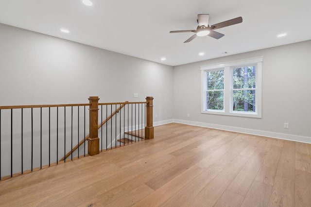 unfurnished room with ceiling fan and light hardwood / wood-style floors