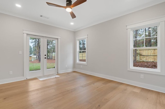 unfurnished room with plenty of natural light, ceiling fan, light wood-type flooring, and french doors