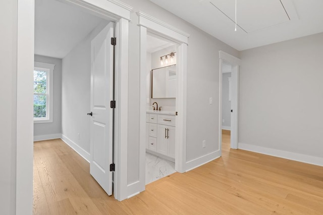 hallway featuring light hardwood / wood-style floors and sink