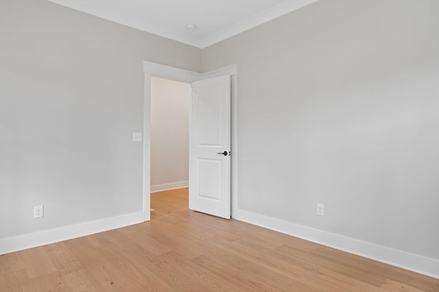 unfurnished room featuring light hardwood / wood-style floors and crown molding