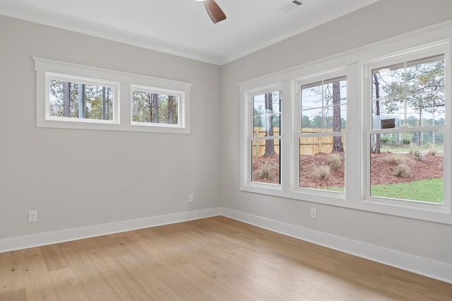 empty room featuring light hardwood / wood-style floors, ceiling fan, and crown molding