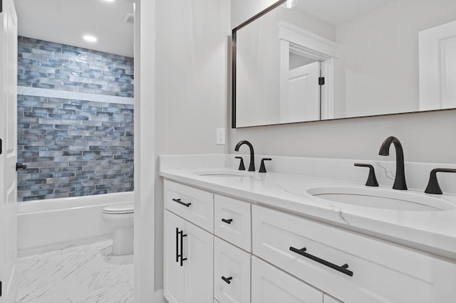 full bathroom featuring vanity, toilet, and tiled shower / bath