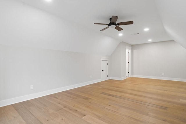 bonus room with ceiling fan, light hardwood / wood-style flooring, and vaulted ceiling