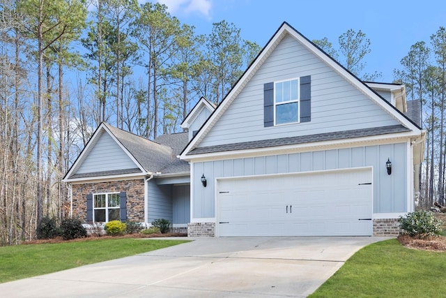 view of front of property with brick siding, a shingled roof, board and batten siding, a front yard, and driveway