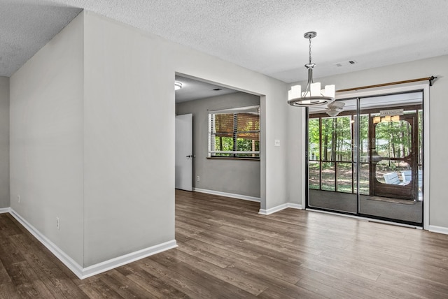 108 Ashwood Pt, Eatonton, GA 31024 - unfurnished room featuring a chandelier, a textured ceiling, wood finished floors, and baseboards