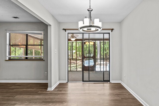 108 Ashwood Pt, Eatonton, GA 31024 - doorway featuring a chandelier, wood finished floors, plenty of natural light, and a textured ceiling