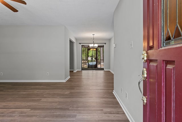 108 Ashwood Pt, Eatonton, GA 31024 - foyer entrance featuring dark wood-type flooring, baseboards, ceiling fan, and a chandelier