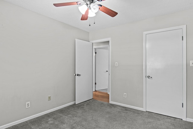 108 Ashwood Pt, Eatonton, GA 31024 - unfurnished bedroom with carpet floors, baseboards, a ceiling fan, and a textured ceiling