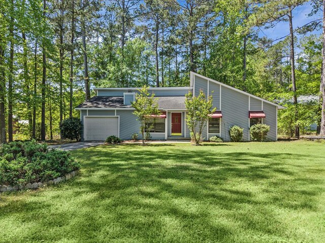 108 Ashwood Pt, Eatonton, GA 31024 - mid-century modern home with a garage, a front yard, asphalt driveway, and roof with shingles