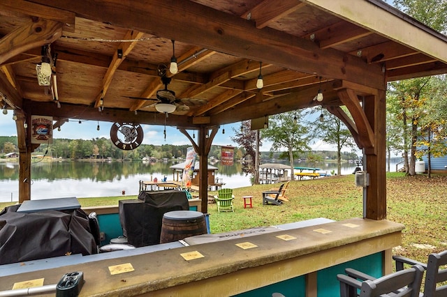 exterior space featuring a gazebo, a yard, and a water view