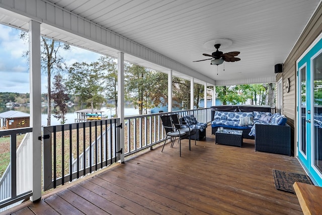 wooden terrace featuring ceiling fan, a water view, and an outdoor hangout area