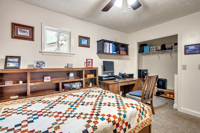 bedroom featuring carpet, a textured ceiling, a closet, and ceiling fan