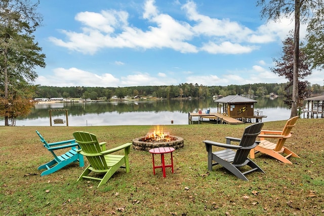 exterior space featuring a gazebo, a water view, and an outdoor fire pit