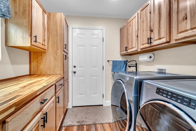 laundry area featuring separate washer and dryer, cabinets, and light wood-type flooring