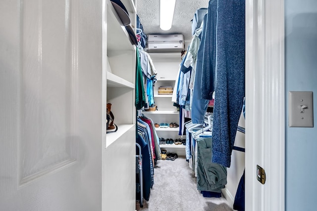 walk in closet featuring light colored carpet