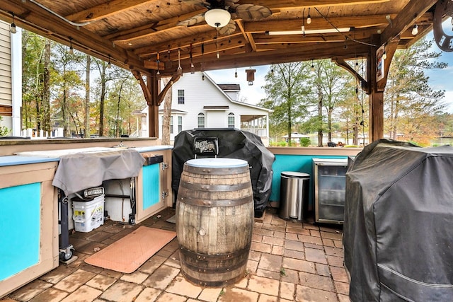 view of patio with area for grilling and ceiling fan