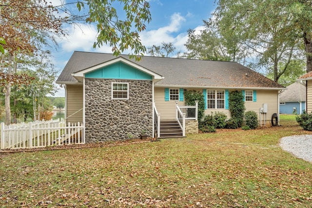 rear view of house with a lawn