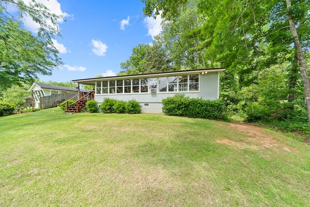 back of property featuring stairway and a sunroom
