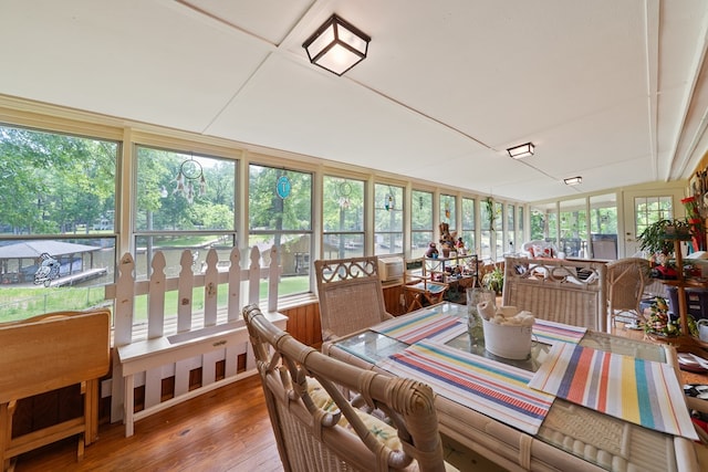 sunroom / solarium with hardwood / wood-style floors