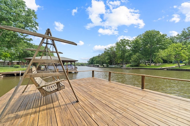 dock featuring a water view and view of scattered trees