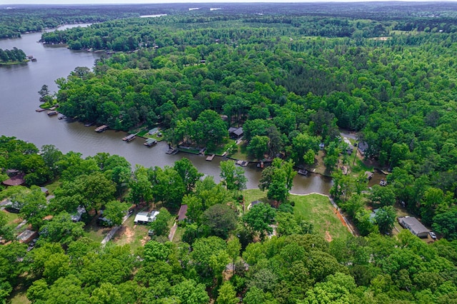 drone / aerial view of a nearby body of water and a forest