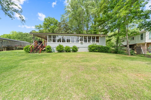 rear view of property featuring stairway and a sunroom