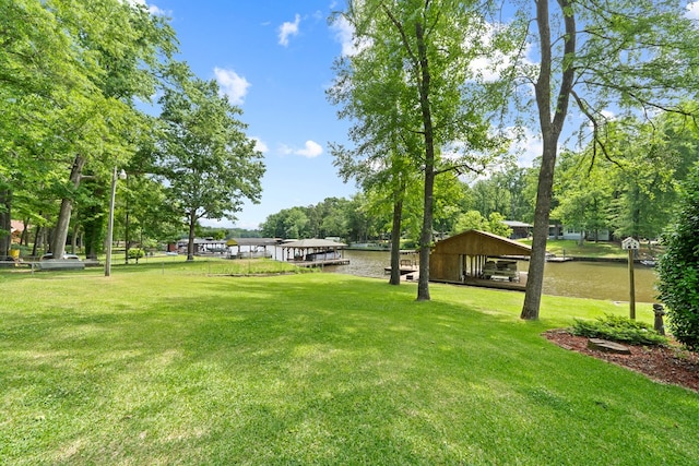 view of community with a lawn and a water view