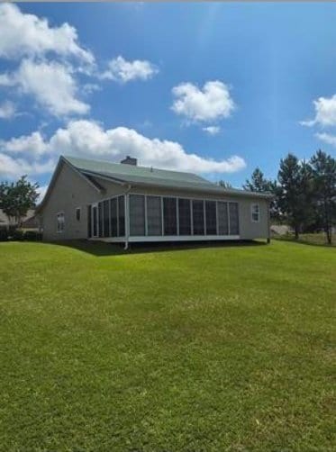179 Garrett Dr, Eatonton, GA 31024 - back of property with a sunroom and a yard