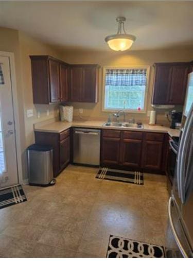 179 Garrett Dr, Eatonton, GA 31024 - kitchen with stainless steel dishwasher, plenty of natural light, and light countertops
