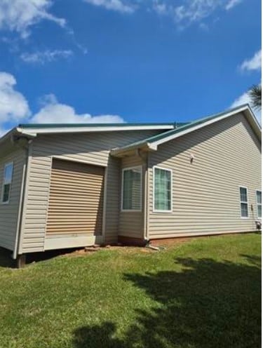 179 Garrett Dr, Eatonton, GA 31024 - back of property featuring a lawn