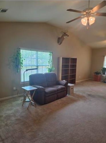 179 Garrett Dr, Eatonton, GA 31024 - living room with lofted ceiling, carpet floors, and ceiling fan