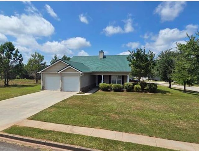 179 Garrett Dr, Eatonton, GA 31024 - view of front of house with an attached garage, a front yard, concrete driveway, and a chimney