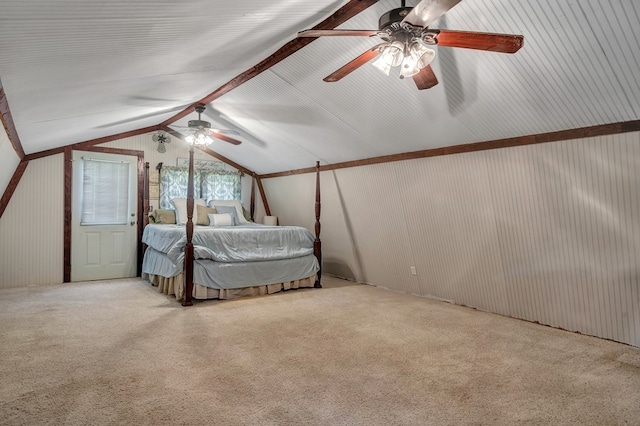 unfurnished bedroom featuring lofted ceiling with beams, carpet, and ceiling fan