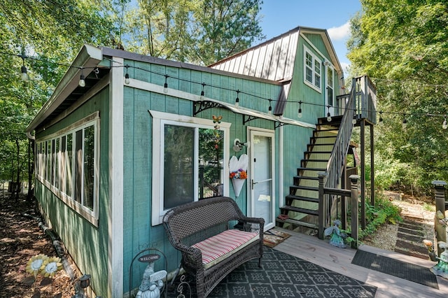 view of outbuilding featuring stairs